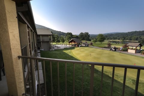 Enjoy peaceful balcony views overlooking the rolling greens and scenic mountain backdrop.