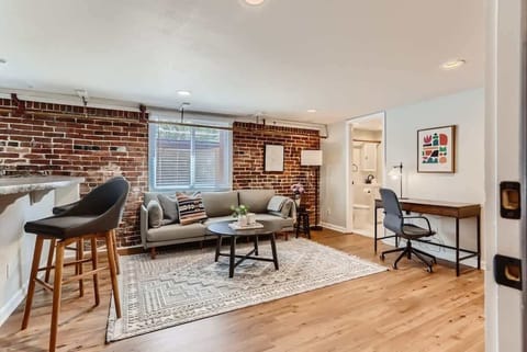 A multifunctional space where relax on the couch, sit at the bar top, or work at the desk
