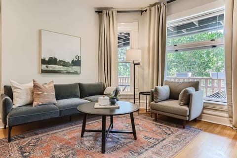 Bright and spacious living room with floor to ceiling windows