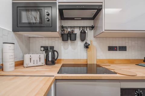 A shared kitchen with the essentials you need for a comfortable stay. Please note, the fridge is located privately in the room, not in the kitchen.
