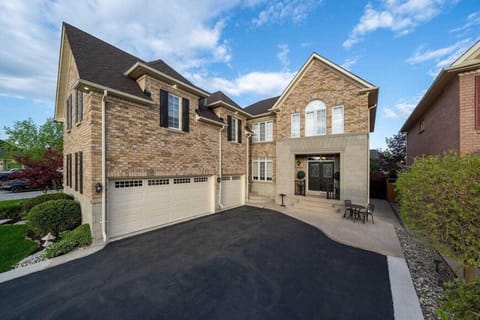Spacious driveway and charming home facade, perfect for a comfortable stay.