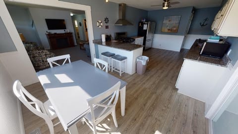 Chef's kitchen with ample seating, cooking tools, and lakeview for dining.