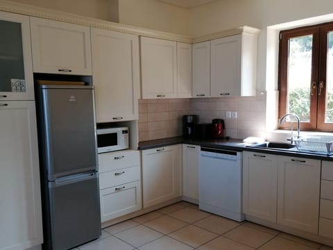 fully equipped kitchen features modern appliances and ample counter space.