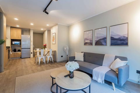 Cozy living area with modern decor and a fully equipped kitchen, perfect for relaxing and dining in style.