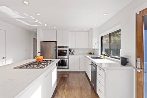 Gourmet kitchen with 5 burner gas Bertazoni stove top, Kitchen Aid appliances, double oven, Berkey water filter system, & Breville Espresso maker