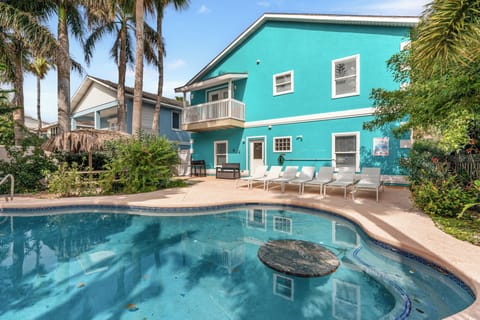 Beautiful backyard oasis with sparkling pool and tropical palms