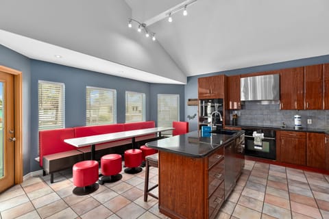 Modern kitchen with bar seating and sleek stainless steel appliances