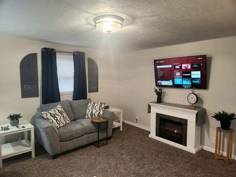 Living room w/ 55" SmartTV and fireplace