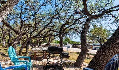 Escape to an outdoor haven where grilling meets chilling under the trees.