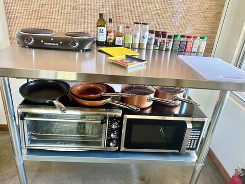 kitchenette, two burner stovetop, microwave, toaster oven, pots pans, oil,spices