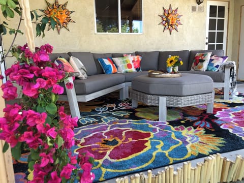 Large out door sectional in private courtyard lush garden.
