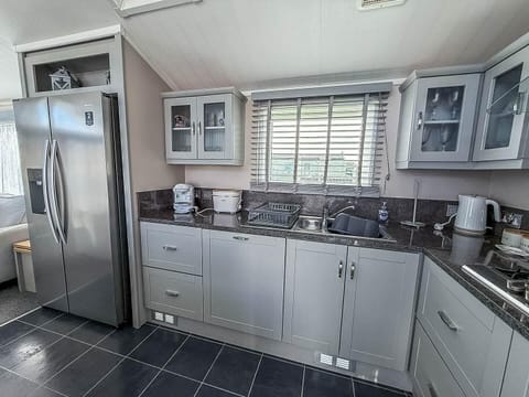 Modern kitchen with sleek appliances and ample natural light