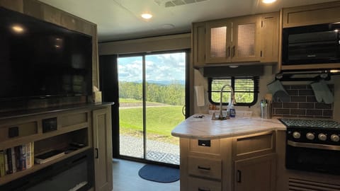 Modern kitchen with mountain views framed perfectly through sliding glass doors.