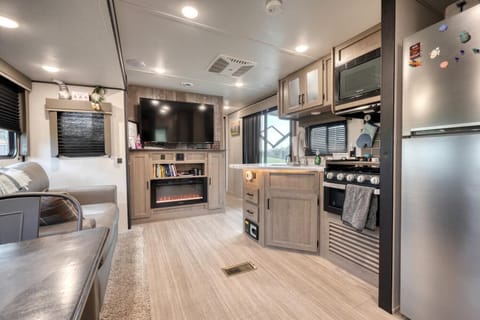 Modern interior with fireplace, full kitchen, and plenty of natural light.