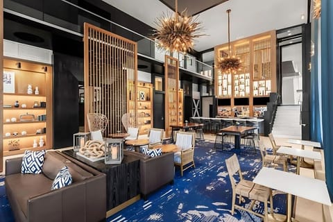 Gather for cocktails in a stylish, sunlit social lounge.