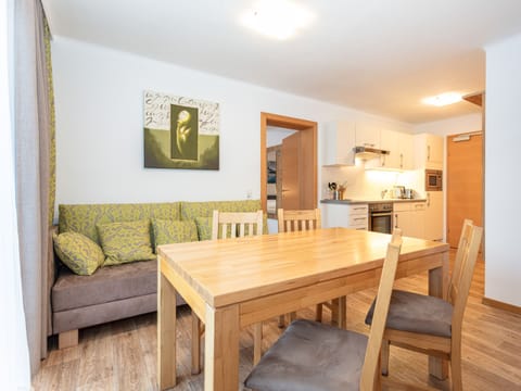 Dining room in Appartements Hollin by we rent apartments in Saalbach, with a table, and chairs. Mountain view.