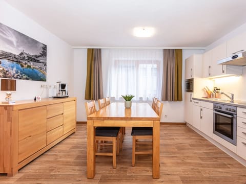 Dining room in Appartements Hollin by we rent apartments in Saalbach, with a table, and chairs. Mountain view.