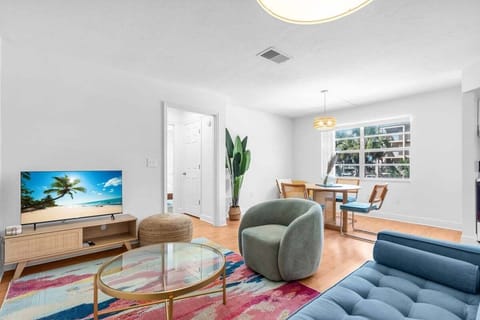 Main living room with ample seating, dining today and bright sunshine gracing the windows.