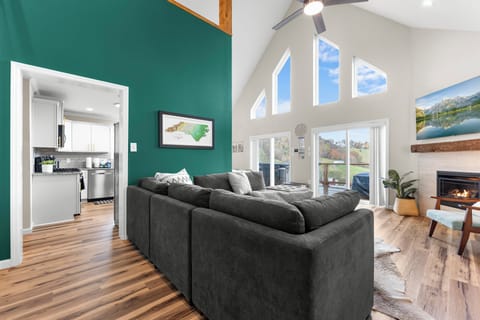 Spacious open-concept living room with vaulted ceilings, and gas fireplace
