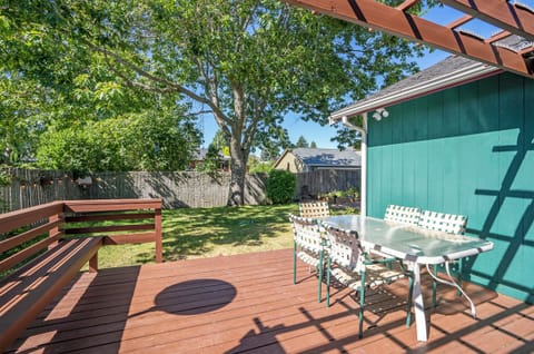 fully fenced back yard with a deck.
