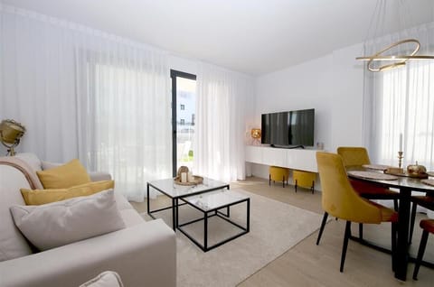 Bright and stylish lounge area with dining area for four guests and access to the terrace