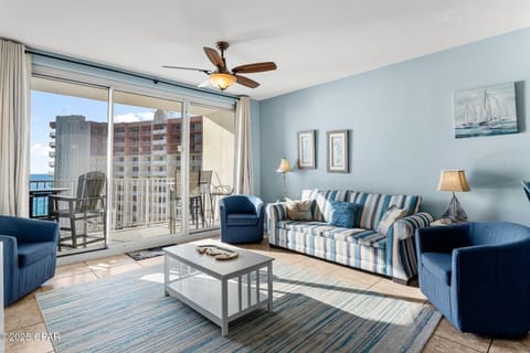 Open concept living area with balcony access and sleeper sofa