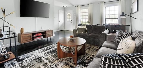 Relax in this bright, airy living room with plush sofas, a modern entertainment system, and cooling ceiling fans—perfect for unwinding after a day at Old Settlers Park or Kalahari Waterpark!