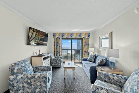 Relax in the comfort of a large well-appointed living room with an ocean view.