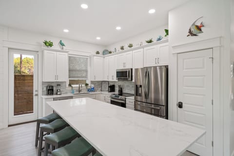 The kitchen island has extra seating and a lot of counter space.