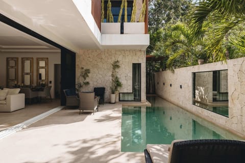 Impressive patio with a pool. Large windows open up, allowing the interior space to connect with the exterior.