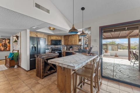 Modern and efficient—everything you need to create a delicious meal. The kitchen features a stainless steel refrigerator, stove, coffee maker, kitchenette oven, kettle, and blender.