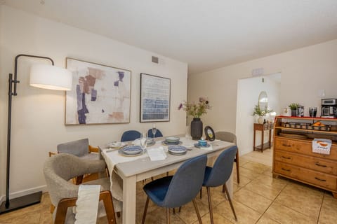 Light filled dining room with 6 seats, spacious layout, and artistic touches.