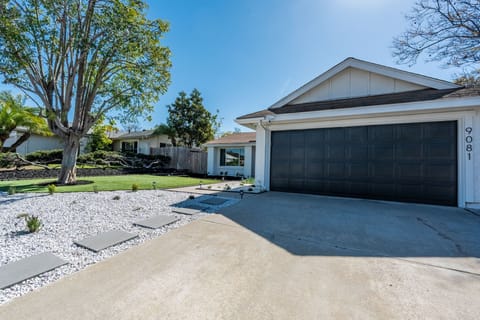 Welcoming home with 2-car garage and beautifully landscaped yard.