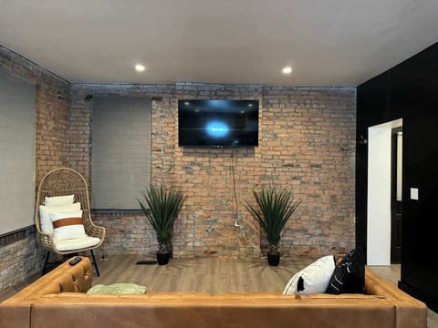 Enjoy the spacious, inviting living room at Russel Masterhouse where modern decor and comfortable seating create a relaxing Columbus Airbnb retreat. Perfect for unwinding and socializing! 