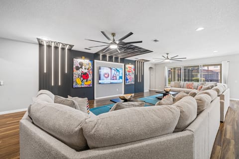 - Game room with pool table foosball and air hockey  
- Colorful dragon mural and modern lighting design  
- TV entertainment and seating for endless family fun