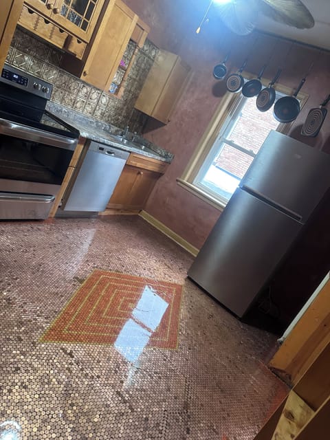 Full kitchen with dishwasher, microwave, refrigerator and pots and pans.