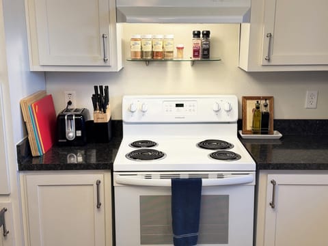 A fully stocked kitchen with spices, organic olive oil and balsamic vinegar.
