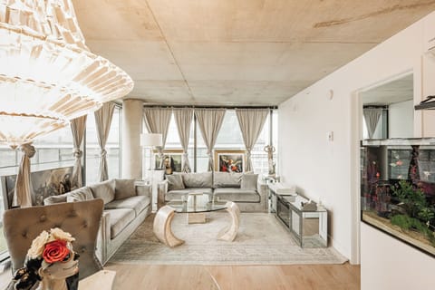 Elegant open-concept living room with panoramic windows and natural light