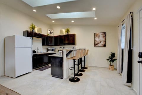 Kitchen/Dining Area has fridge/freezer, stove/oven, dishwasher, microwave and seating for 4 guests.