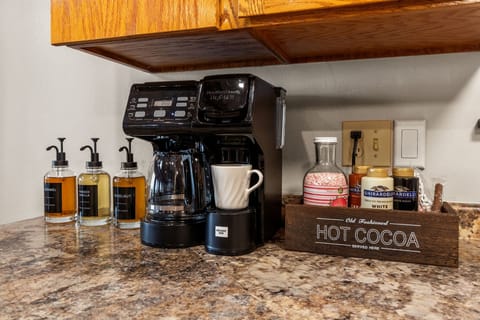 Start your morning at the fully stocked coffee bar, featuring a dual coffee maker and all the essentials for the perfect brew.