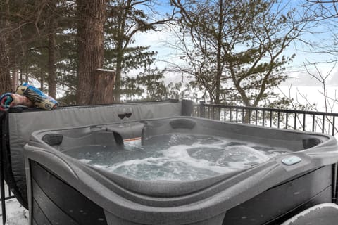 Sink into the warm, bubbling hot tub, feeling the day’s stress melt away as you take in the peaceful lake view.