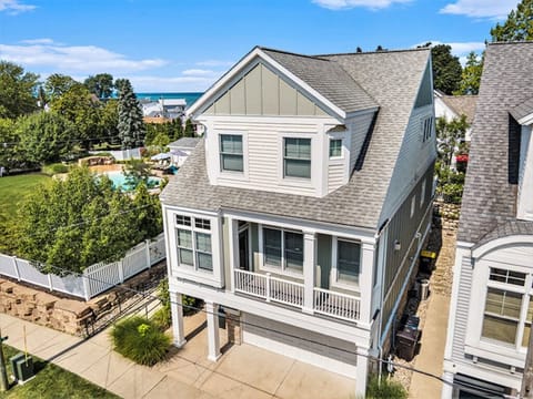 Aerial view of the front of the house with the pool and recreation area behind.