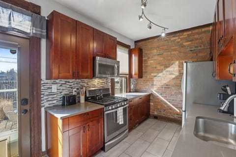 Kitchen with gas range and microwave.
