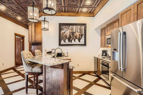 Granite kitchen island with stylish bar stools.