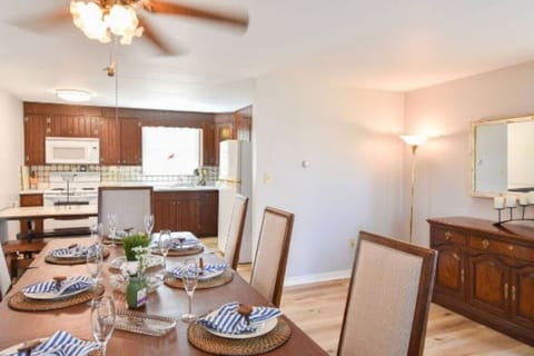 Warm and inviting kitchen with charm, a fully stocked setup, and a dining table perfect for shared meals and gatherings.