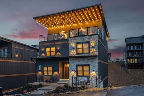 Evening rooftop view with dramatic sky and cozy lighting.