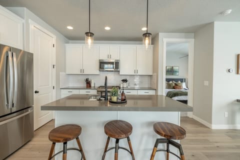 Fully equipped kitchen with stainless appliances and ample storage.