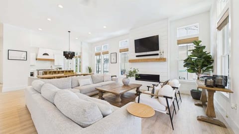 Open concept living area with stylish furnishings and huge TV