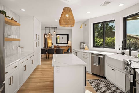 Newly-renovated large kitchen with farmhouse sink is perfect for making meals and memories.