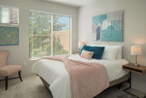 Sweet dreams await in this calming, well-lit bedroom with blinds for added privacy.